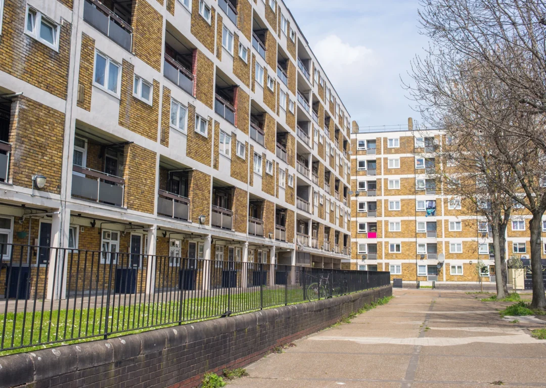 Tall buildings lined up in a row, representing housing provision in an urban environment.